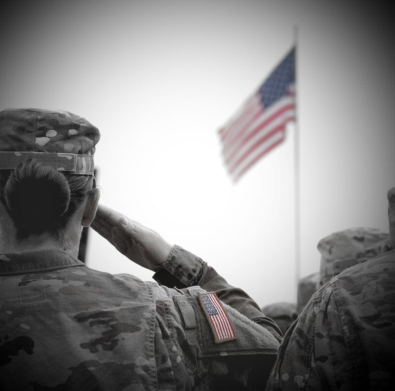 Veteran saluting flag