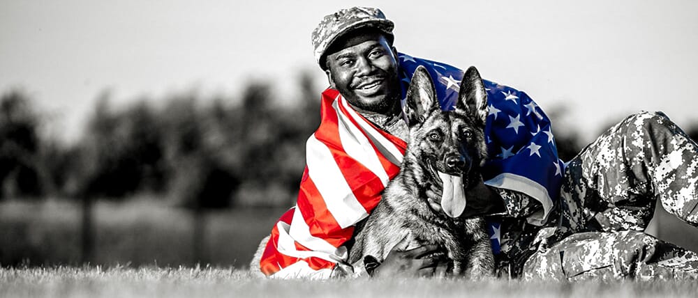 Veteran with flag and dog